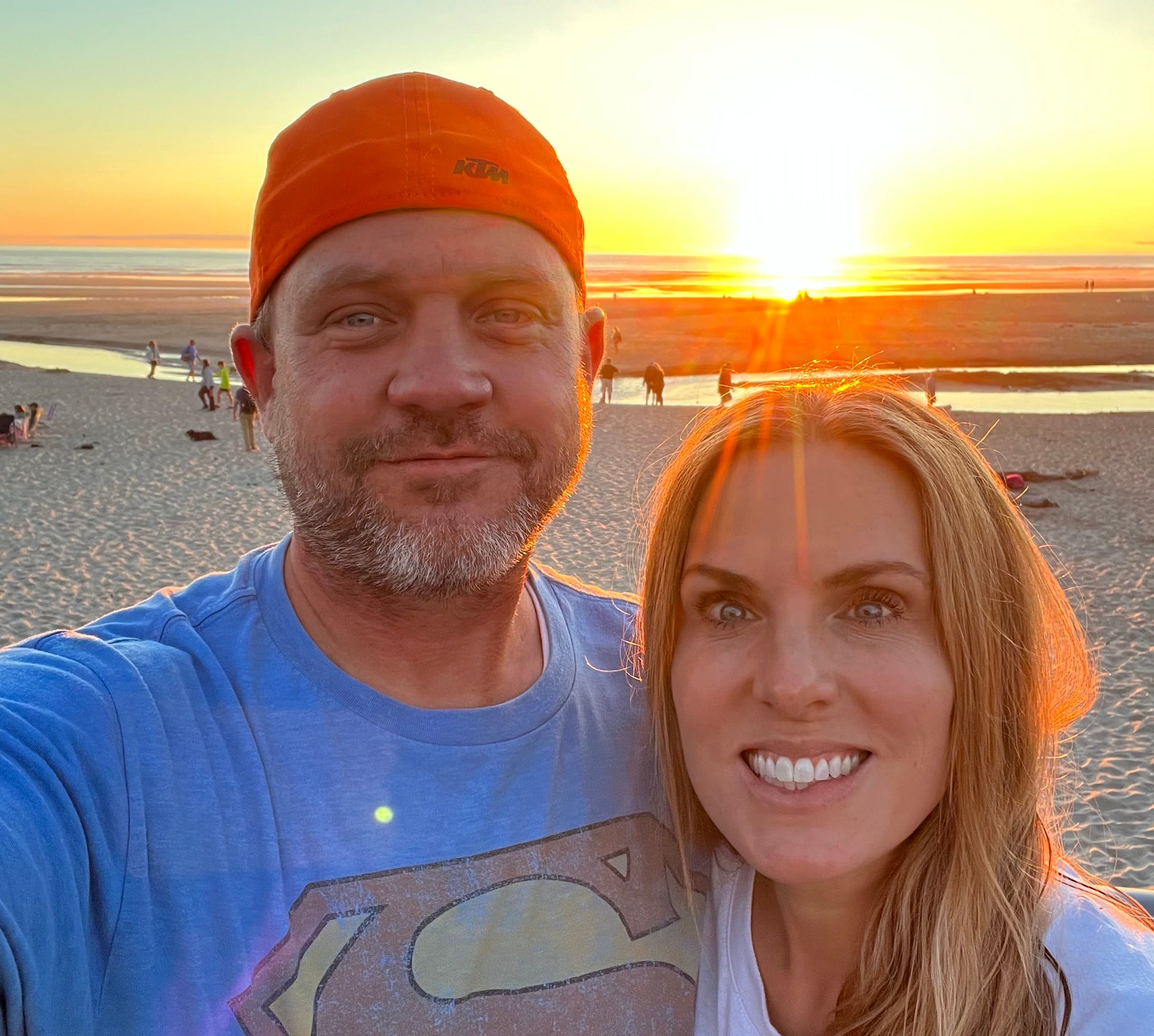 Dave and his wife at the beach during sunset